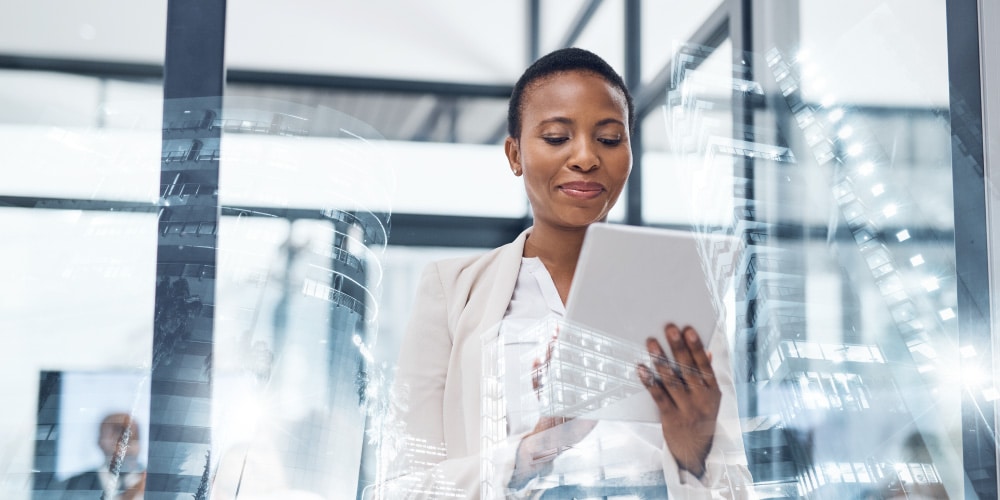 Women using tablet in brightly lit workspace